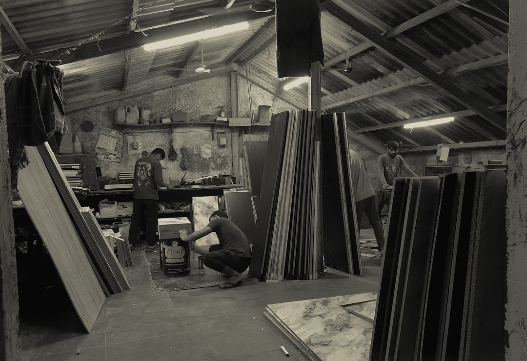 Workers in a workshop with stacked materials