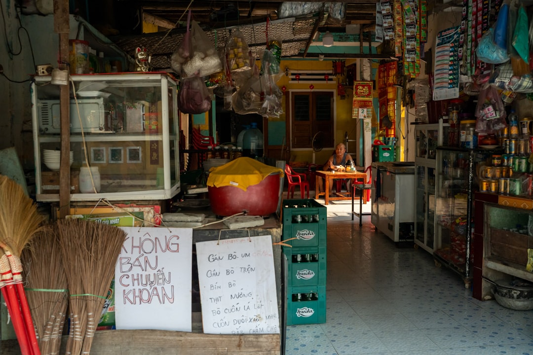A cluttered storefront with goods and signs visible signage